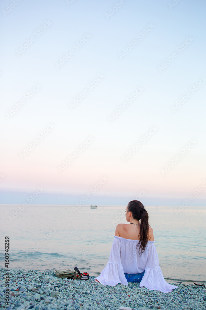 Young woman enjoying summer day on the beach. Beach vacation in Europe