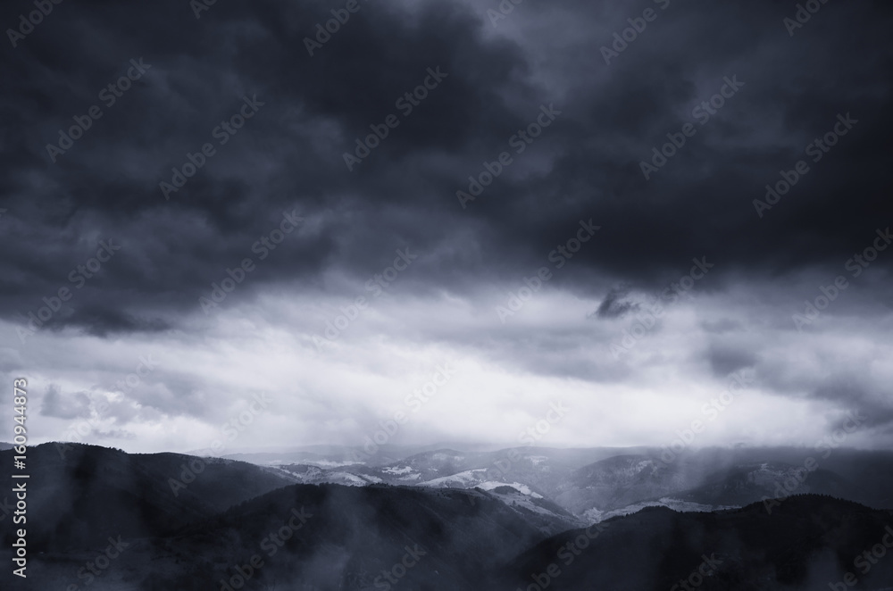 dramatic storm clouds in dark landscape