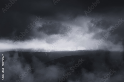 dark fantasy landscape with dramatic storm clouds at dusk