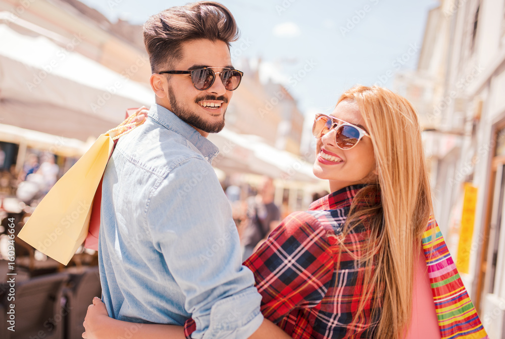 Shopping time. Young couple in shopping. Consumerism, love, dating, lifestyle concept Shopping time. Young couple in shopping. Consumerism, love, dating, lifestyle concept