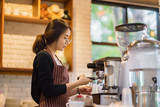 barista woman making latte art at coffee shop,equipment, coffee shop,cafeteria people and technology concept