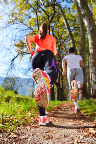 Young couple jogging in park at morning. Health and fitness.