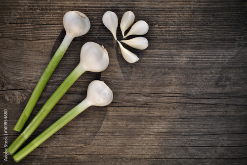 Fresh garlic and garlic bulblet on wooden background