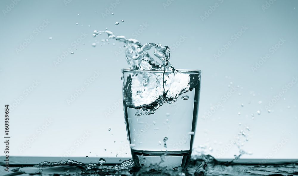 Water splash in glass. Drinking water concept Water splash in glass. Drinking water concept