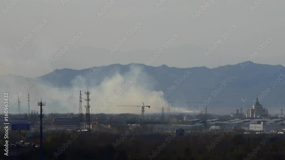 Panoramic of city town & factory smoke rely on mountain,industrial tower at dusk. Panoramic of city town & factory smoke rely on mountain,industrial tower at dusk.