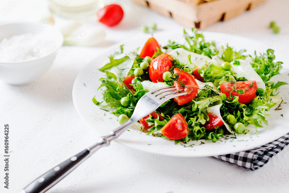 Fresh and healthy fitness salad with lettuce, peas, cherry tomato, cucumber, green onion, dill, sunflower or olive oil and toast on a white background Fresh and healthy fitness salad with lettuce, peas, cherry tomato, cucumber, green onion, dill, sunflower or olive oil and toast on a white background