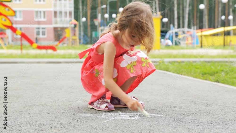 Little girl drawing with the chalk on asphalt outdoors Little girl drawing with the chalk on asphalt outdoors