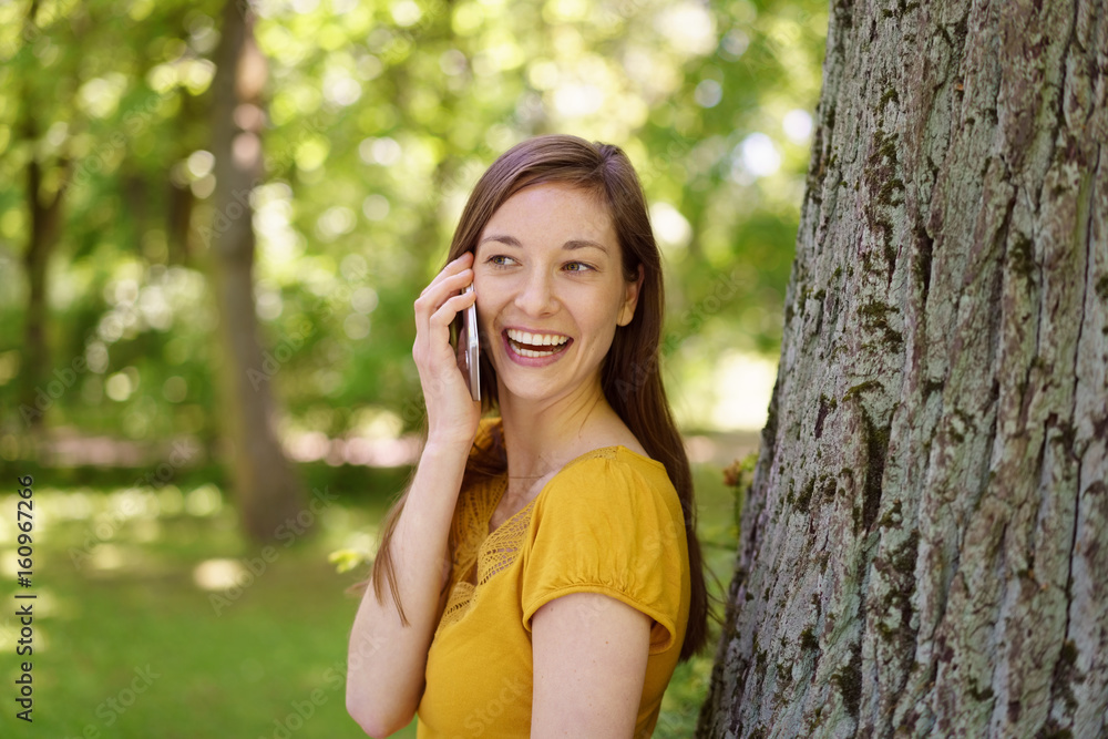 Laughing young woman chatting on her mobile Laughing young woman chatting on her mobile