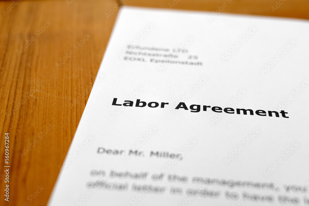 A letter on a wooden table - employment agreement A letter on a wooden table - employment agreement