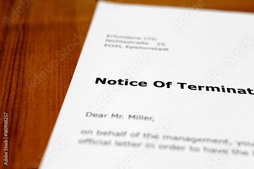 A letter on a wooden table - notice of termination