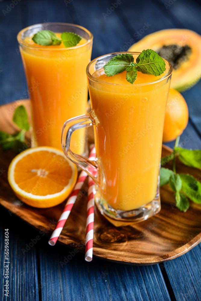 Fototapeta premium Healthy papaya, orange and mango smoothie