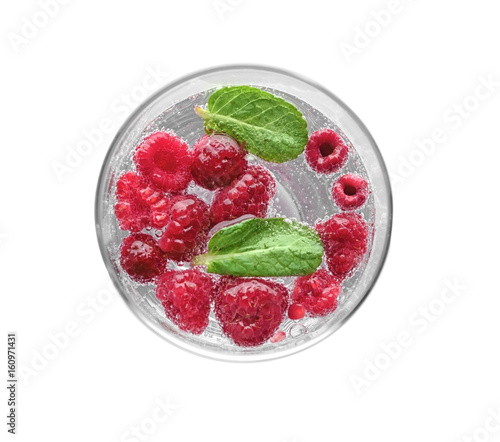 Tasty refreshing lemonade with berries in glass on white background