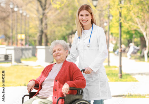 Young nurse and disabled el...