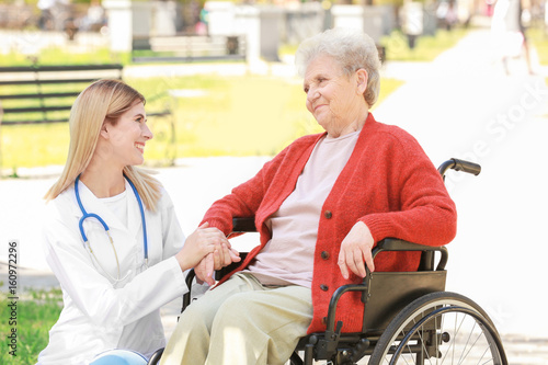 Young nurse and disabled el...