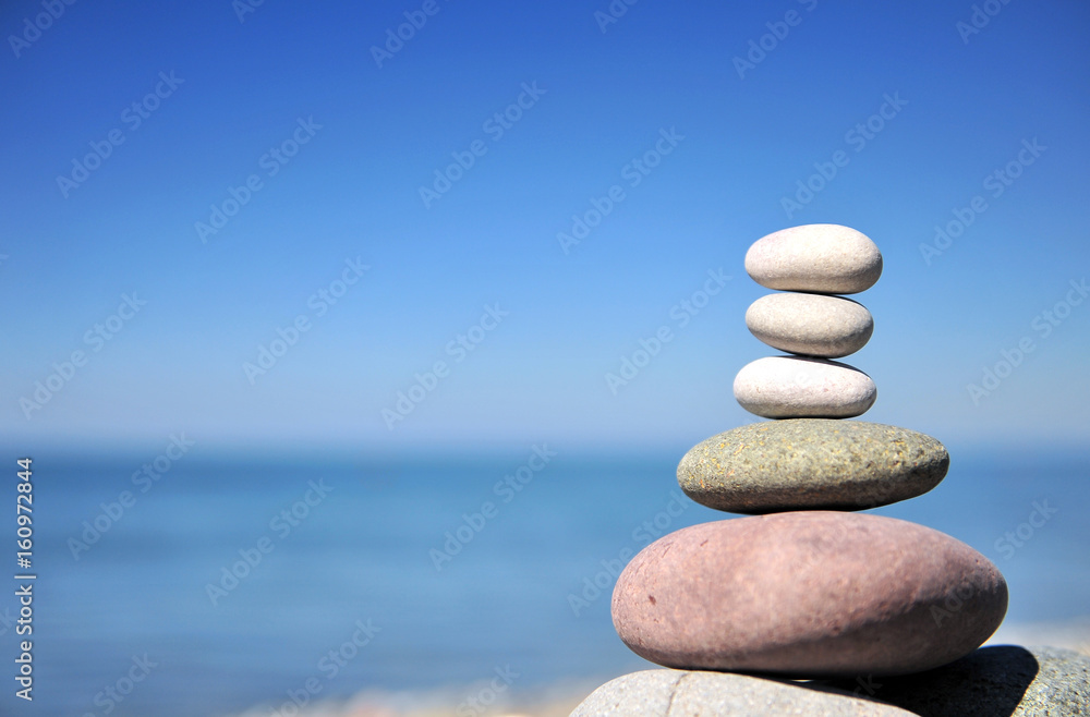 Stones pyramid with the sea and sky Stones pyramid with the sea and sky