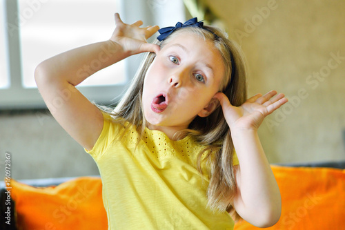 Little girl making funny face and showing her tongue