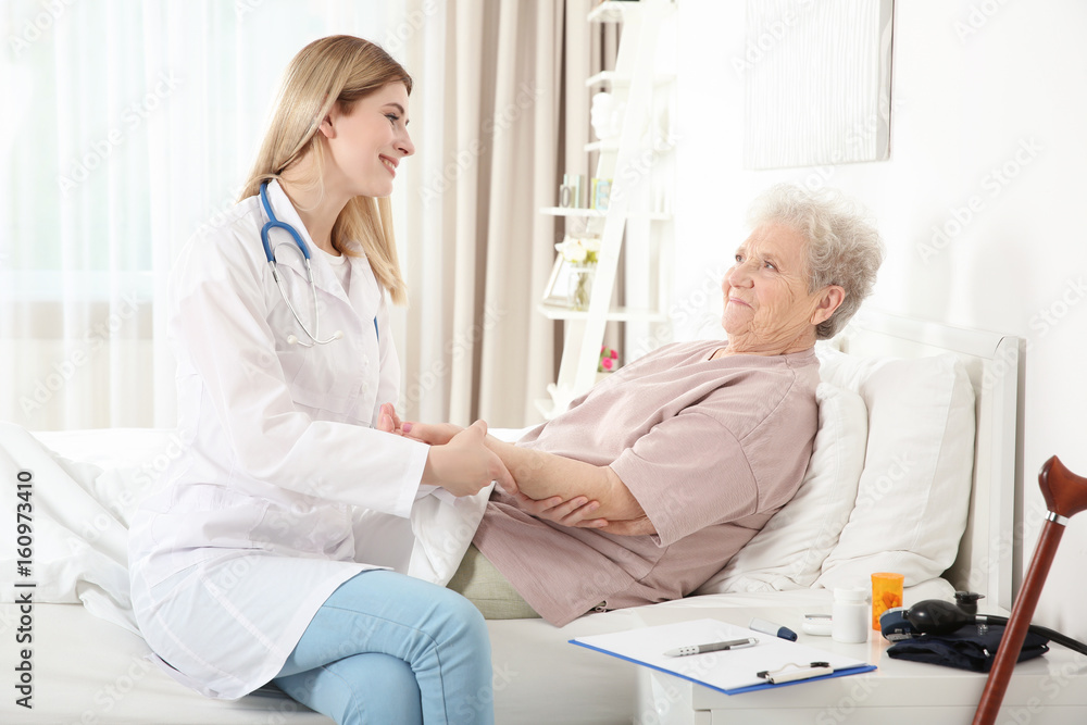 Young nurse examining elderly woman at home Young nurse examining elderly woman at home