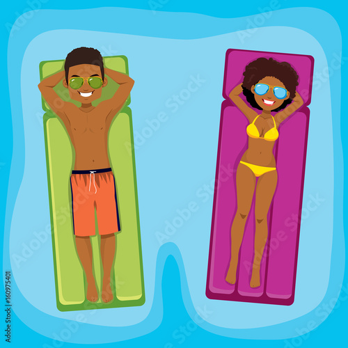 Young African American couple enjoying relaxing time floating with inflatable on swimming pool