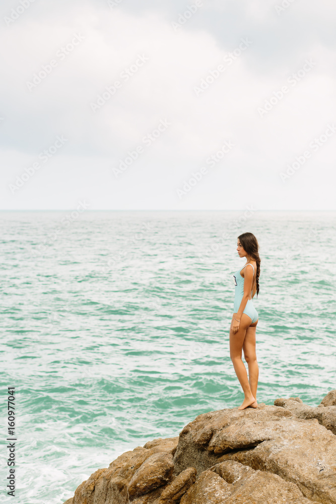 Beautiful sexy girl in full body swimsuit with long healthy hairs