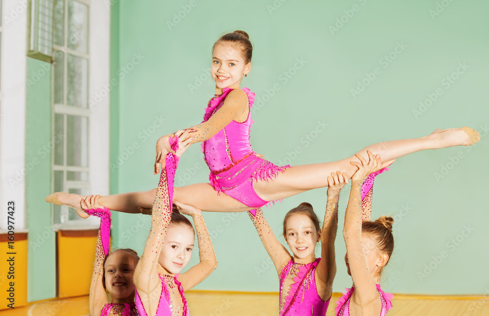 Happy girls performing rhythmic gymnastics element Stock Photo | Adobe ...