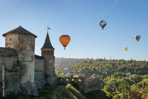 Hot air balloons over european town