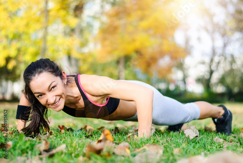 Pretty sporty woman doing exercises in the park