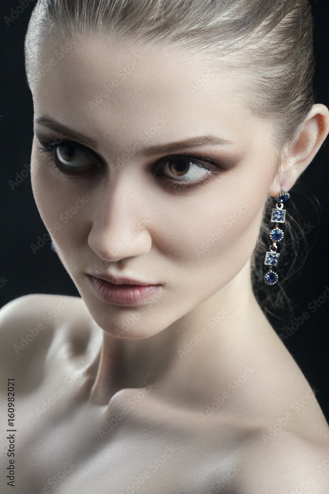 Fototapeta premium serious luxury woman model with professional makeup on black background