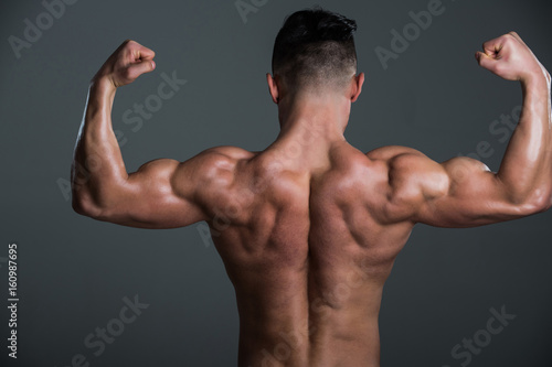 muscular man with muscle torso showing biceps and triceps