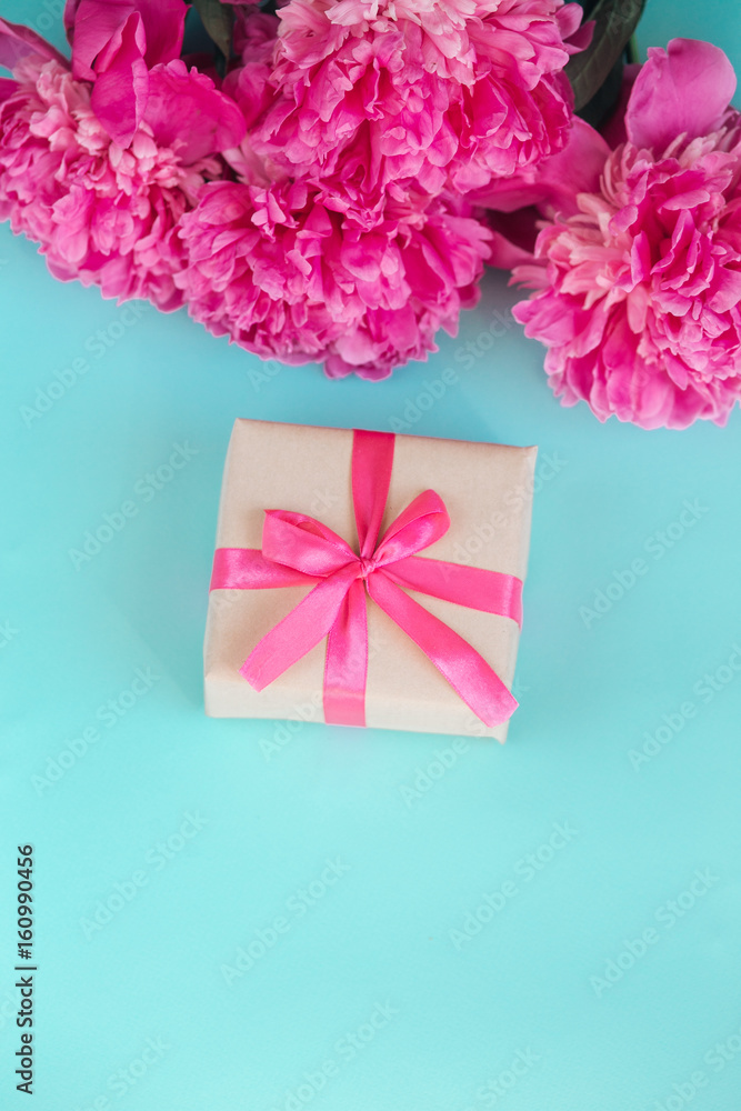 Beautiful fresh pink peony flower with gift box on mint background. Peonies summer.Mothers day or Womens day Beautiful fresh pink peony flower with gift box on mint background. Peonies summer.Mothers day or Womens day