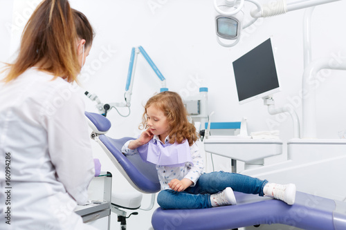 Little girl in chair visiting dentist