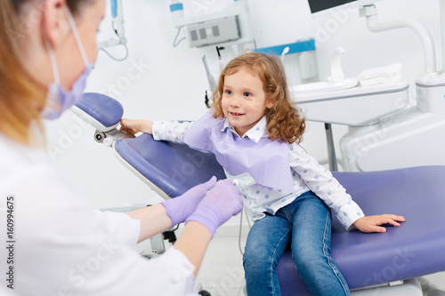 Smiling girl visiting dentist