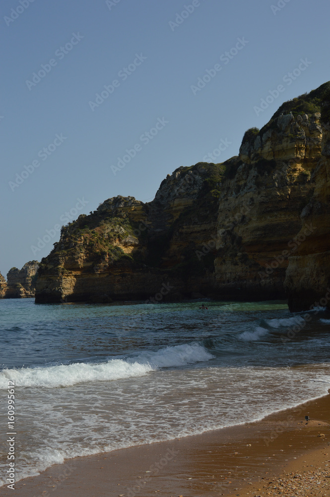 Atlantic ocean view of Algarve coastline. Beautiful seascape sunny beach in Lagos Portugal. Dream vacation picturesque destination. Serenity location for relaxation and contemplation.