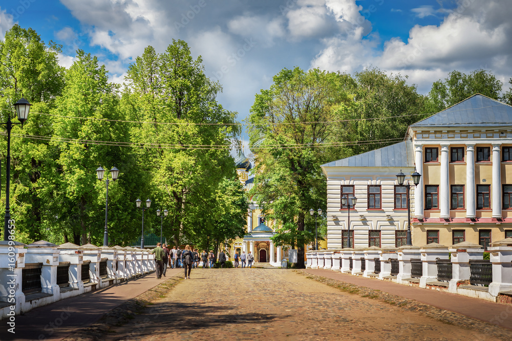 Alley park near the building in the style of Russian classicism and the facade of the Epiphany Cathedral in Uglich, Russia.