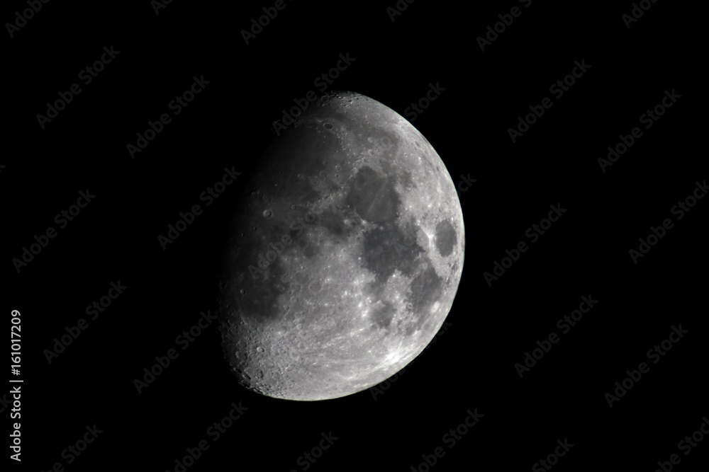 Right side view of a quarter moon with a black background Right side view of a quarter moon with a black background