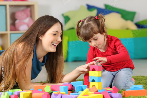 Mother and daughter playing with construction toys