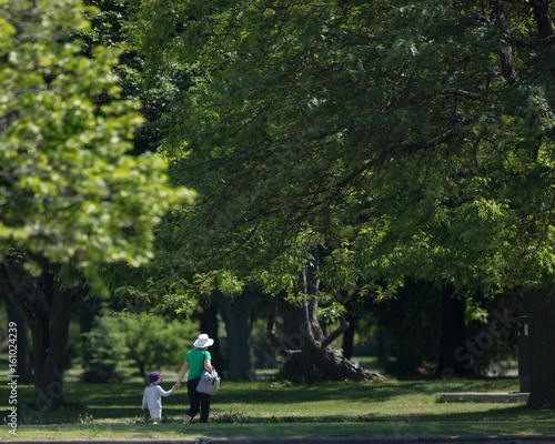 Child and Grandmother walking in the park