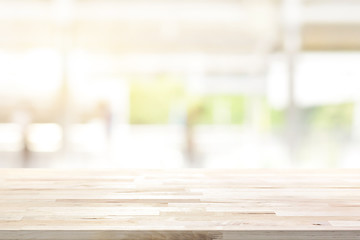 Wood table top on blur kitchen window background