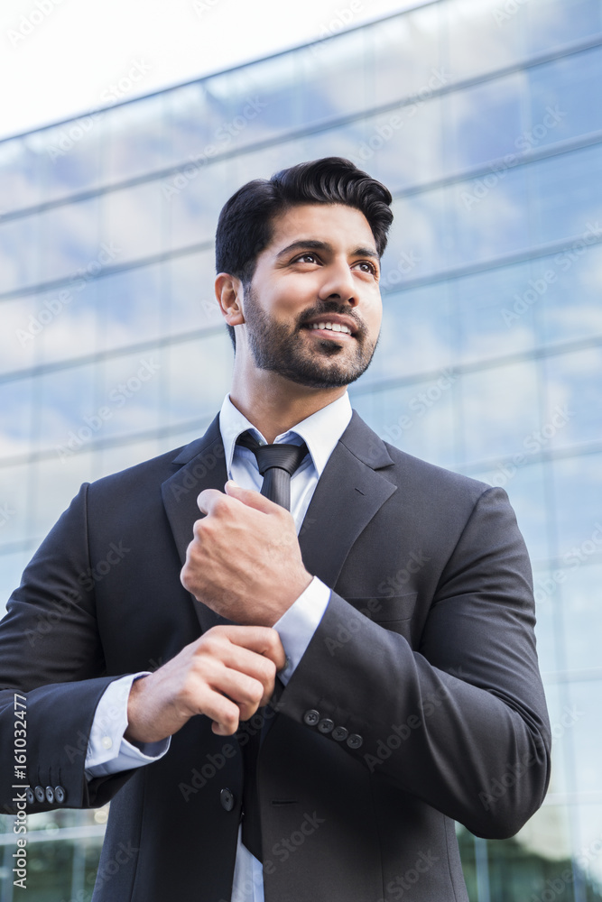 Successful businessman or worker standing in suit and straightens shirt Successful businessman or worker standing in suit and straightens shirt