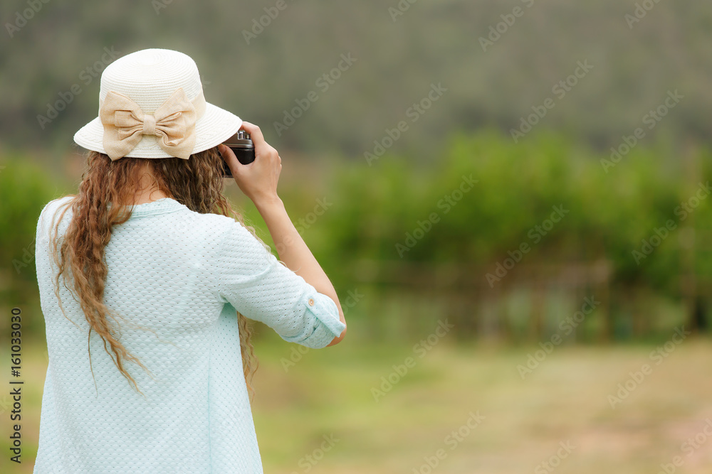 Woman taking photo of nature scene