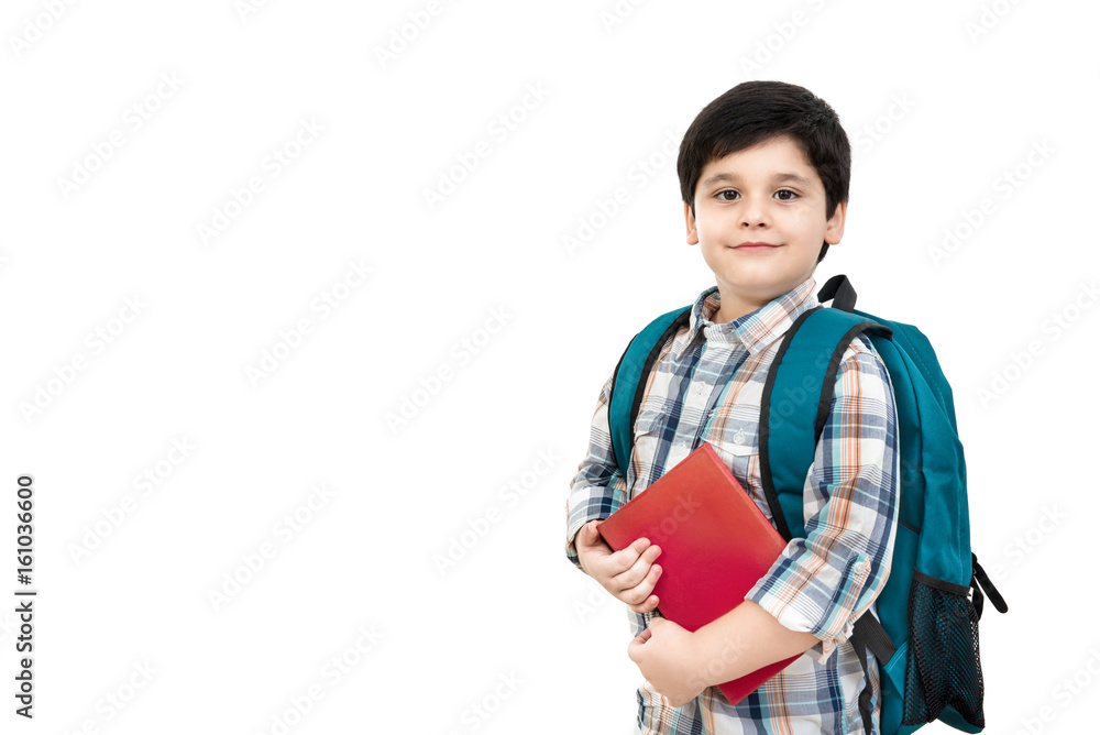 Cute Asian boy carrying school bag and holding book in hands Cute Asian boy carrying school bag and holding book in hands