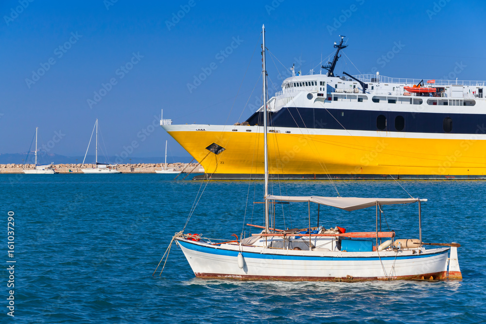 Yellow passenger ferry and small fishing boat