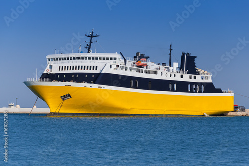 Yellow passenger ferry moored in port © evannovostro