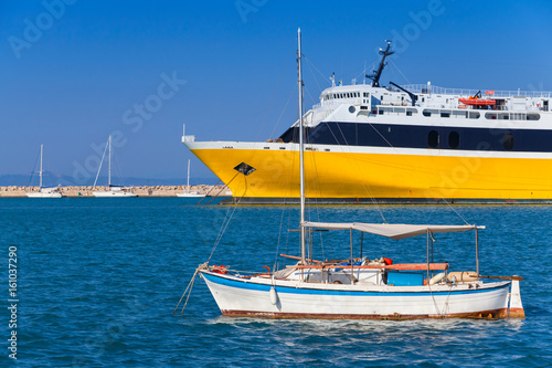 Yellow passenger ferry and small fishing boat © evannovostro