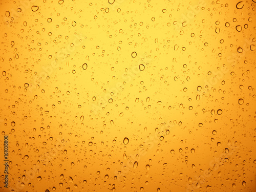 Rain water drop on yellow metal.