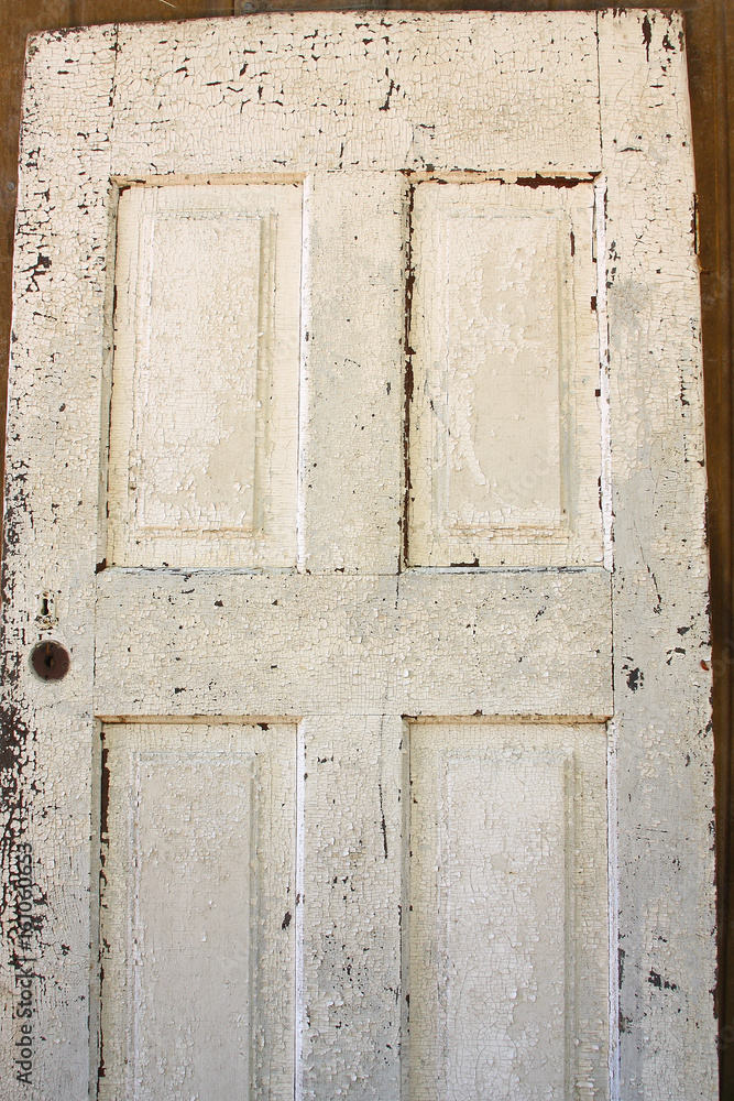 Old door with peeling paint, background