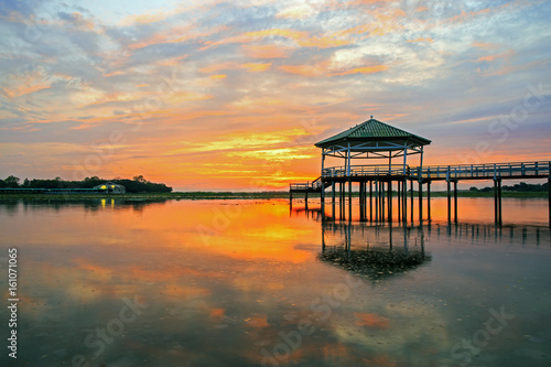 Sunset at the Pavilion on lake or pond or swamp of Bueng See Fai, Phichit, Thailand. © Phongsak