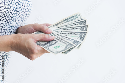 A person holding dollar money with two hands