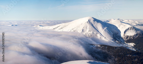 Winter landscape of the Carpathian Mountains in Ukraine. The top is tight fog and obscured by clouds.