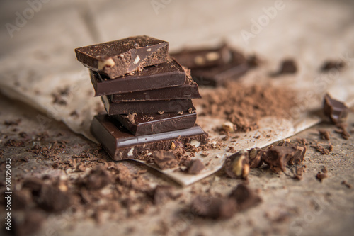 Dark chocolate stack with hazelnuts, selective focus