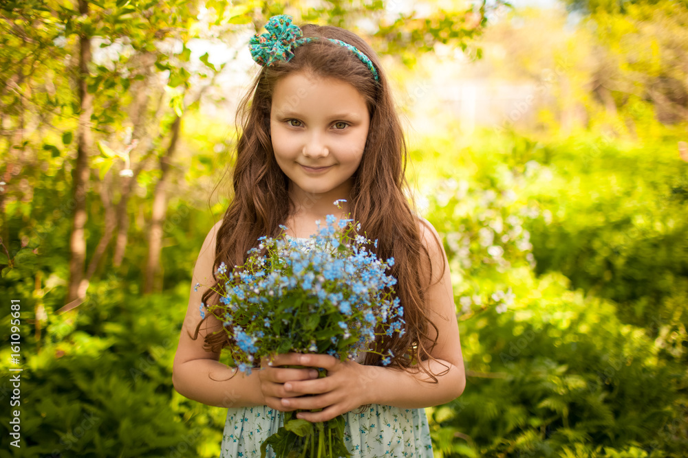 Girl with a bouquet of wild blue flowers Girl with a bouquet of wild blue flowers